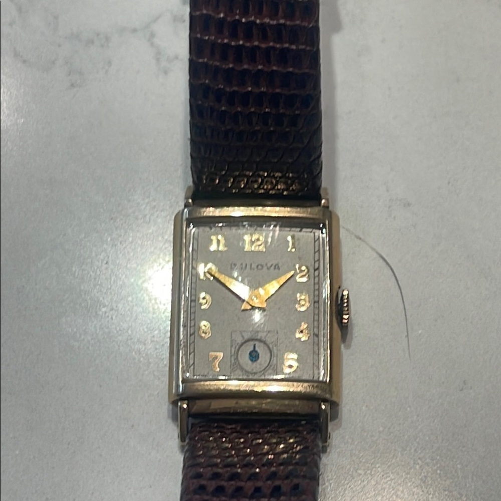 Vintage Bulova gold tank shaped watch. Windup. Good condition